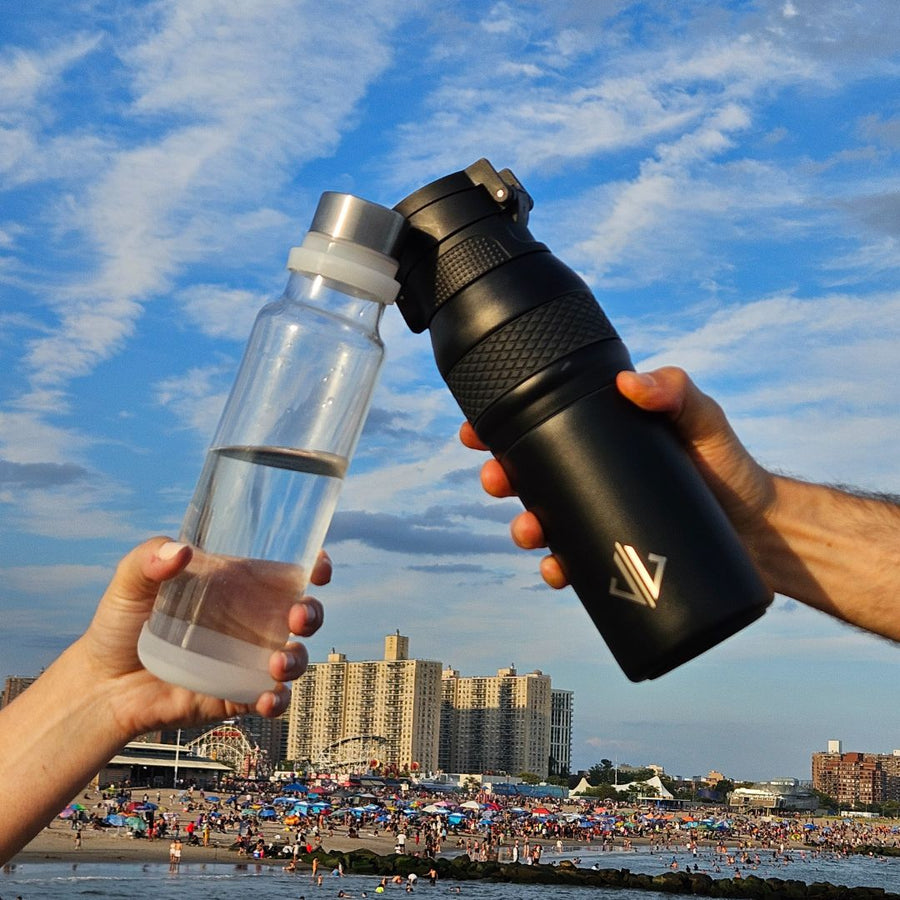The glass vessel and its insulated shell raised together against the sky